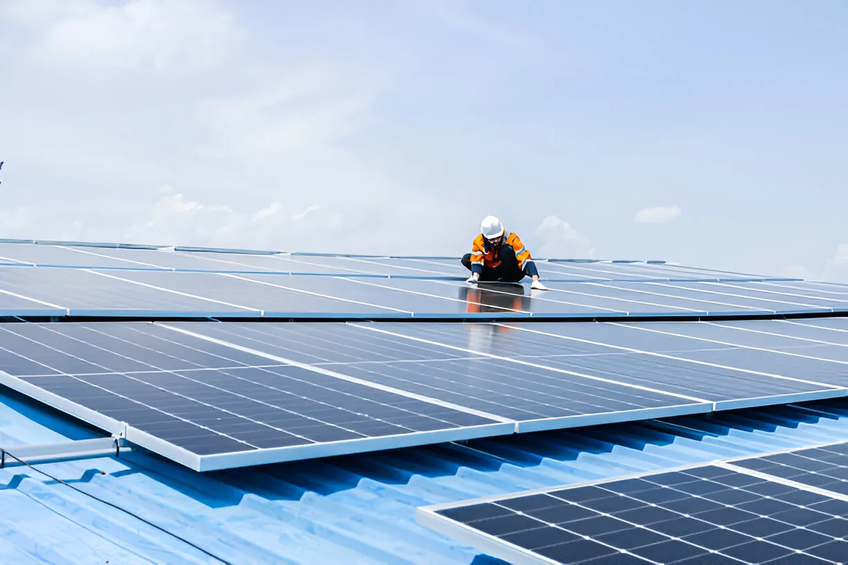 Technicians cleaning solar panels